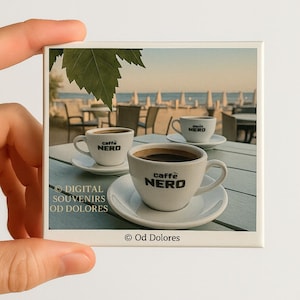 May include: A square magnet featuring three cups of coffee on saucers, each with the "caffè NERO" logo. The image has a beach scene background with a leaf in the upper left corner. The magnet also has the text "DIGITAL SOUVENIRS OD DOLORES" and "© Od Dolores".
