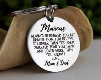 May include: Silver keychain with a round tag engraved with the message "Always remember you are braver than you believe, stronger than you seem, smarter than you think and loved more than you know! Love, Mom & Dad" and the name "Marcus".