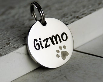 May include: Silver dog tag with the name "Gizmo" engraved on it and a paw print.