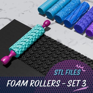 May include: A set of foam rollers in various shades of blue and purple, with a teal roller in the foreground. The rollers have textured patterns and pink handles. A black patterned mat and the text "STL FILES FOAM ROLLERS - SET 3" are also visible.