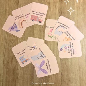 May include: A collection of pink cards featuring illustrations of a rainbow, a fire engine, a rocket, and a butterfly. Each card has a short phrase. The text at the bottom reads "Evening Anchors by Little Spicy Minds".