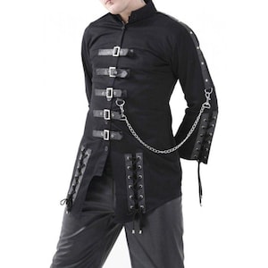 May include: Black long-sleeve shirt with multiple leather straps and silver buckles. The shirt features a stand-up collar, lace-up detailing, and a silver chain. The sleeves have leather accents and are also laced up. The shirt is a gothic style.