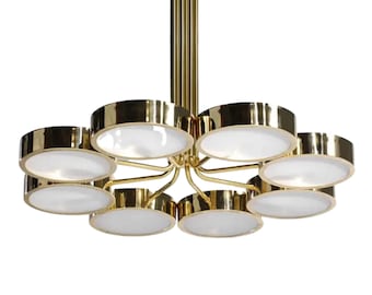 May include: A gold-toned, eight-light chandelier with a central stem and radiating arms. Each light features a circular, gold-rimmed shade with a white, opaque diffuser. The fixture is designed for ceiling mounting and has a modern aesthetic.