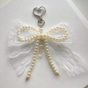 Pearl bow bag charm, Elegant white bow keychain, Girly bow purse charm, Handmade pearl bow charm, Lace ribbon bag charm