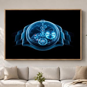 May include: A rectangular wall art piece featuring a glowing blue X-ray style illustration of a mechanical wristwatch with visible internal gears and a link bracelet set against a solid black background, framed in a light-toned wooden frame.