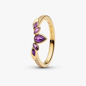 May include: A gold-colored ring featuring a leaf-like design with five purple gemstones. The ring has a band with small, clear stones and the brand name "Pandora" engraved on the side. The gemstones are in a teardrop and oval shape.