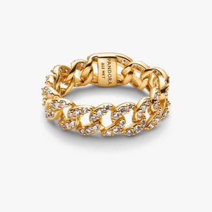 May include: A gold-colored ring with a chain link design. The ring is encrusted with small, clear gemstones. The brand name "PANDORA ALE MET" is engraved on the ring's clasp. The ring is a statement piece of jewelry.