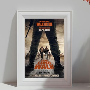 May include: Framed movie poster for "The Long Walk" by Stephen King. The poster features the text "Walk or Die" and "The Long Walk" in orange and white. The image shows a person's legs and feet, with other people walking in the distance. The release date is September 12.