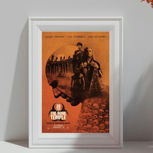 May include: Framed movie poster for "The Bone Temple" with an orange and brown color scheme. The poster features actors Ralph Fiennes, Jack O'Connell, and Alfie Williams. Text includes "Fear is the New Faith" and "January 14".