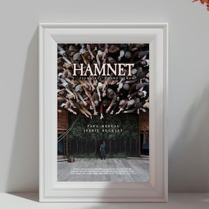 Puede incluir: Póster de película enmarcado para "Hamnet" con borde blanco. El póster presenta una multitud de personas que se extienden hacia arriba, con el título en la parte superior. Los nombres Paul Mescal y Jessie Buckley también son visibles.