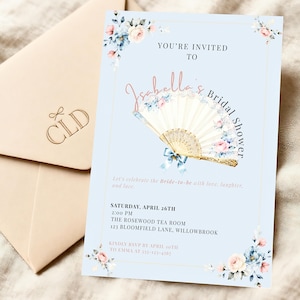 May include: A pale blue bridal shower invitation with floral decorations and the text "Isabella's Bridal Shower." The invitation includes event details. A matching envelope is also present, with the initials "CLD" printed on it.