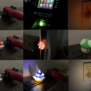 Könnte beinhalten: Eine Sammlung von Nachtlichtern und Dekorationsartikeln, die von Videospielcharakteren inspiriert sind. Die Lichter zeigen Designs wie einen grünen Schildkrötenpanzer, einen roten Stachelpanzer, einen grünen Pilz und einen blauen geflügelten Panzer. Jedes Licht wird in eine Standardsteckdose gesteckt.