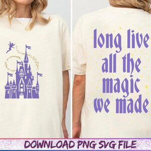 May include: Cream-colored t-shirt featuring a purple castle graphic with a fairy and gold glitter accents on the front. The back of the shirt displays the text "long live all the magic we made" in purple, with yellow star details.