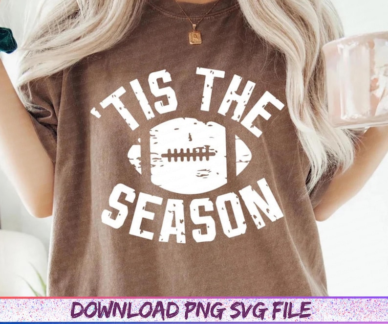 May include: Brown t-shirt with the text "'TIS THE SEASON" in white, featuring a football graphic. The shirt has a vintage, distressed look. The bottom of the image includes the text "DOWNLOAD PNG SVG FILE".