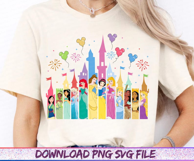 May include: Cream-colored t-shirt featuring a colorful graphic of a castle silhouette with Disney princesses. The design includes balloons, fireworks, and the text "DOWNLOAD PNG SVG FILE" at the bottom.