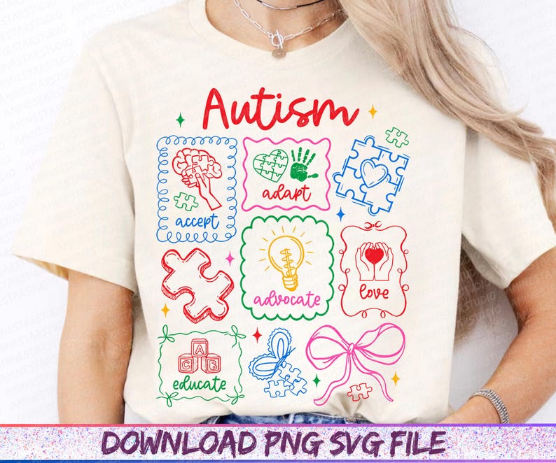 May include: Cream-colored t-shirt with a colorful graphic design featuring the word "Autism" in red script. The design includes puzzle pieces, a brain, a heart, and the words "accept," "adapt," "advocate," "love," and "educate."