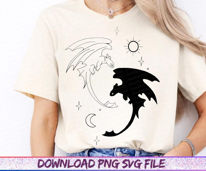May include: Cream-colored t-shirt featuring a black and white dragon design. One dragon is outlined, the other is solid black. The design includes a sun, moon, and stars. The text "DOWNLOAD PNG SVG FILE" is at the bottom.