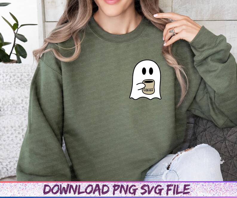 May include: An olive green sweatshirt featuring a white ghost graphic holding a coffee cup. The coffee cup has the word "COFFEE" printed on it. The sweatshirt is a long-sleeved crew neck.