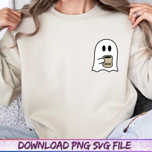 May include: Cream-colored sweatshirt featuring a small graphic of a white ghost holding a coffee cup. The ghost has black eyes and is holding a tan coffee cup with the word "coffee" printed on it. The text "DOWNLOAD PNG SVG FILE" is at the bottom.