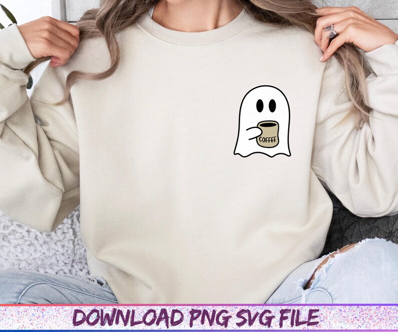 May include: Cream-colored sweatshirt featuring a small graphic of a white ghost holding a coffee cup. The ghost has black eyes and is holding a tan coffee cup with the word "coffee" printed on it. The text "DOWNLOAD PNG SVG FILE" is at the bottom.