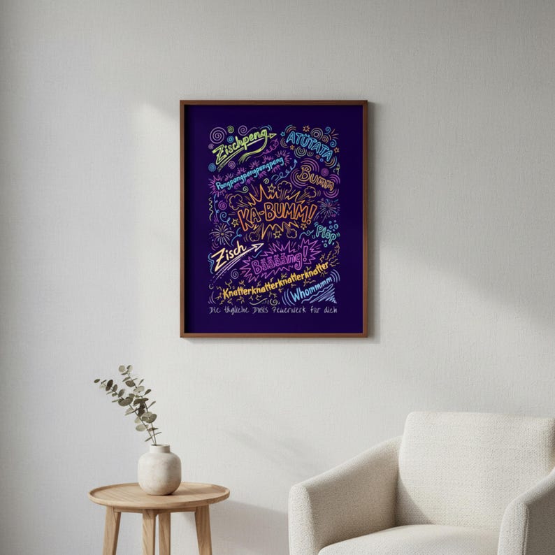 May include: A framed print with a dark purple background features colourful, handwritten text and illustrations. The text includes words like "KA-BUMMI" and "Zisch", with decorative elements. The frame is a dark brown colour.
