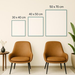 May include: Three framed blank art prints in sizes 30 x 40 cm, 40 x 50 cm, and 50 x 70 cm, with teal frames, are displayed on a cream-coloured wall. Below, two brown leather chairs with black legs are positioned on a light-coloured rug.