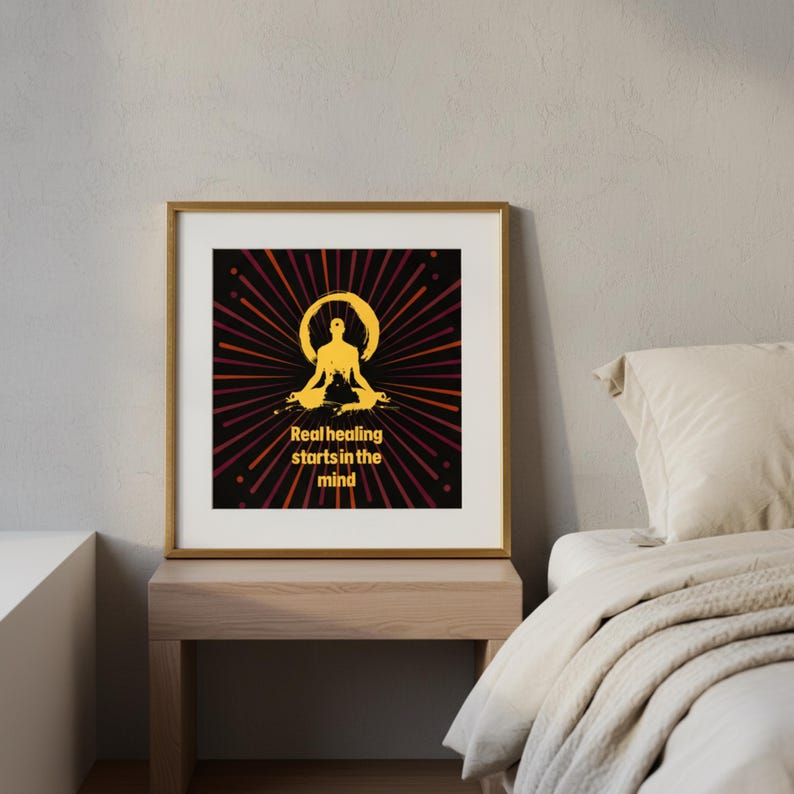 May include: A framed print with a gold frame, displaying a gold-coloured illustration of a meditating figure with a halo, set against a red and black radial design. The text reads "Real healing starts in the mind".