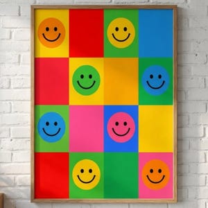 Può includere: Una stampa artistica incorniciata con una griglia di quadrati colorati. Ogni quadrato contiene una faccina sorridente. I quadrati sono di vari colori, tra cui rosso, giallo, verde, blu e rosa. La cornice è in legno.
