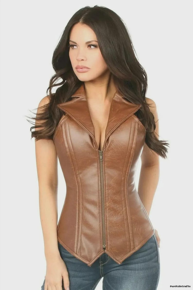 Pu&ograve; includere: Un corsetto in pelle marrone con scollo a camicia e cerniera a tutta lunghezza. Il corsetto ha una silhouette aderente e viene indossato con jeans blu. Lo stile generale &egrave; vintage, steampunk o gotico.