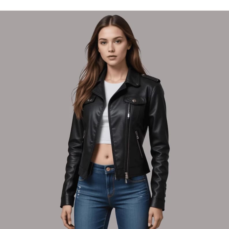 May include: A black leather jacket with a classic biker style. The jacket features a notched collar, zippered pockets, and a front zipper closure. The model is wearing blue jeans and a white top.