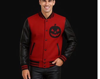 May include: Red and black varsity jacket with a black pumpkin graphic. The jacket has black leather sleeves, black and red striped cuffs, and a black collar. The jacket is buttoned up and has black trim.