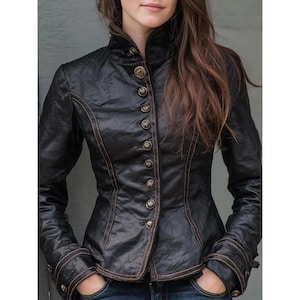 May include: Black leather jacket with a high collar and multiple gold-colored buttons down the front. The jacket has brown stitching and detailing on the cuffs and seams. The sleeves are long, and the jacket appears to be fitted.