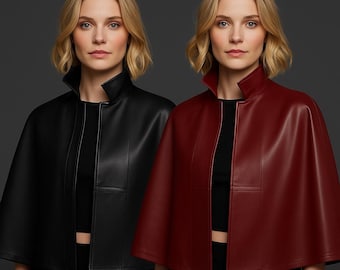 May include: Two leather capes, one black and one burgundy, are displayed. Both capes have a high collar and a front opening. The capes are worn over black tops. The background is a solid, dark gray.