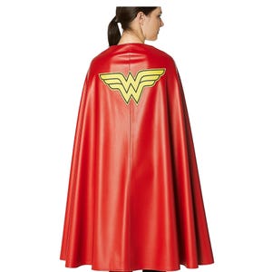 May include: A red cape with a yellow and black emblem on the back. The cape is made of a shiny material and drapes down to the knees. The emblem is a stylized "W" with wings.