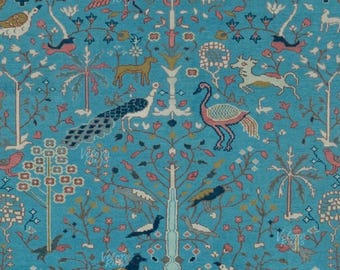 May include: A turquoise area rug with a detailed pattern of birds, trees, and animals. The rug features a central tree design with various birds perched on branches, surrounded by other animal figures. The color palette includes shades of blue, red, and brown.