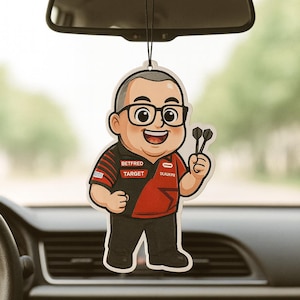 May include: A novelty air freshener in the shape of a cartoon man with glasses, holding darts. The red and black shirt has the words "BETFRED" and "TARGET". The air freshener is suspended by a black string, hanging from a car's rearview mirror.