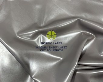 May include: A metallic silver sheet of latex with a smooth, reflective surface. The material is 0.40mm thick and is cut to length. The center of the image features a logo with the text NORDIC LATEX and 0.40MM SHEET LATEX CUT TO LENGTH.