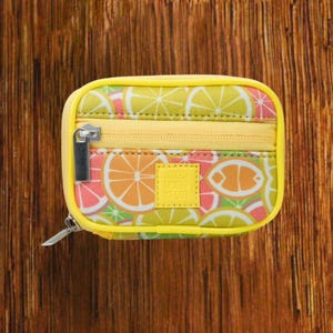 Yellow Background with Citrus Fruits travel pill organizer case closed, compact zippered medication pouch for daily use, portable storage for vitamins and prescriptions.