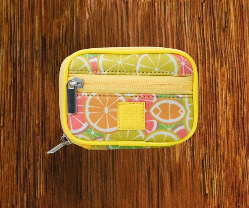 Yellow Background with Citrus Fruits travel pill organizer case closed, compact zippered medication pouch for daily use, portable storage for vitamins and prescriptions.