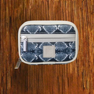 Silver Snakeskin travel pill organizer case closed, compact zippered medication pouch for daily use, portable storage for vitamins and prescriptions.