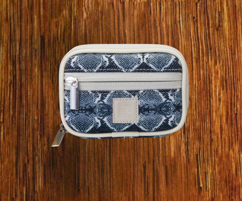 Silver Snakeskin travel pill organizer case closed, compact zippered medication pouch for daily use, portable storage for vitamins and prescriptions.