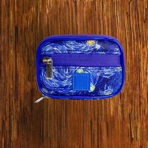 Starry Night travel pill organizer case closed, compact zippered medication pouch for daily use, portable storage for vitamins and prescriptions.
