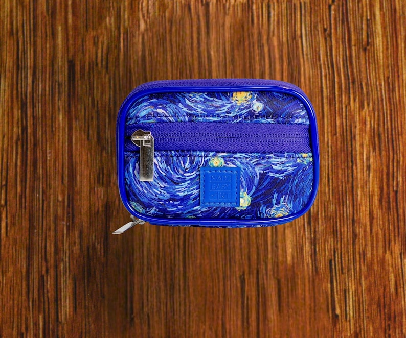 Starry Night travel pill organizer case closed, compact zippered medication pouch for daily use, portable storage for vitamins and prescriptions.
