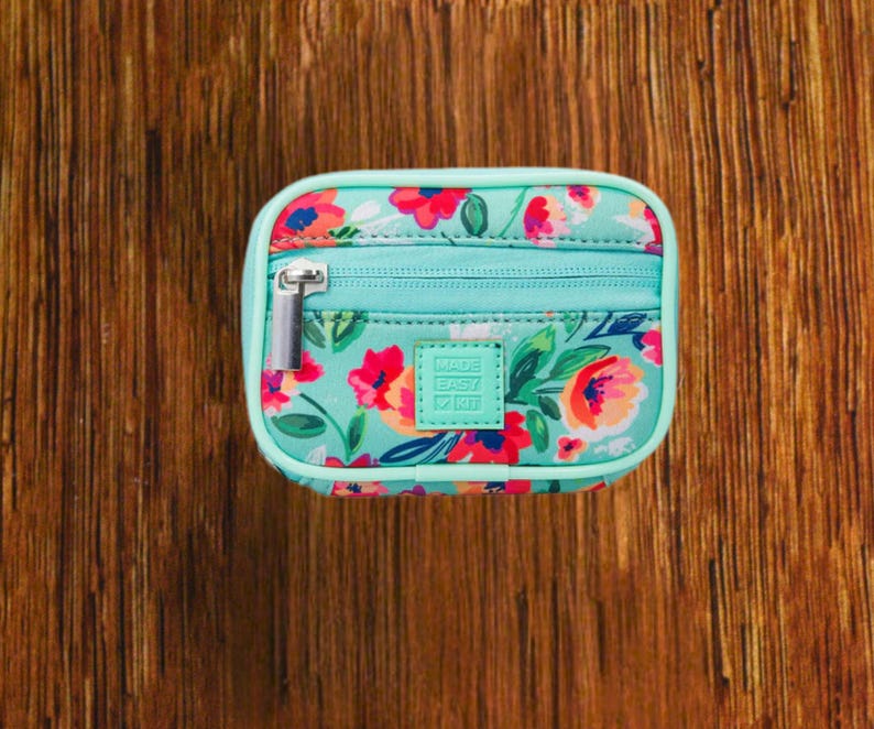 Blue Floral travel pill organizer case closed, compact zippered medication pouch for daily use, portable storage for vitamins and prescriptions.