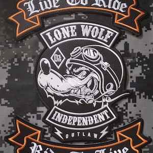 May include: A black and white embroidered patch set featuring a wolf wearing goggles and smoking a cigar. The top banner reads Live To Ride, the center reads Lone Wolf, and the bottom banner reads Ride To Live with Independent Outlaw text.
