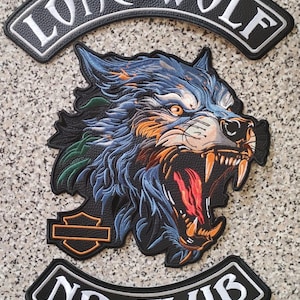 May include: A three-piece embroidered patch set featuring a snarling wolf head with blue, orange, and green fur. The top rocker reads LONE WOLF in white, the bottom rocker reads NO CLUB in white, and a small shield emblem is on the left side.