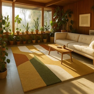 May include: A colorful area rug with a geometric design in shades of yellow, orange, green, and white. The rug is placed in a living room with a cream-colored sofa, wooden coffee table, and numerous potted plants. The room has large windows.