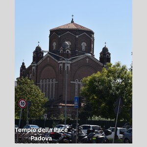 May include: A large brick church with a domed roof and multiple spires. The text "Tempio della Pace Padova" is visible at the bottom of the image. Trees and parked vehicles are in the foreground, with a clear blue sky above.