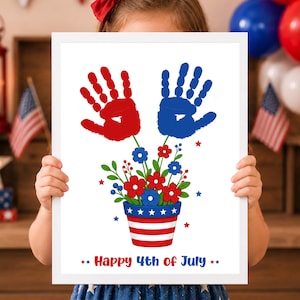 May include: A framed print featuring a red handprint and a blue handprint above a flower pot filled with red and blue flowers. The pot has a white star and red stripe pattern. The text Happy 4th of July is printed in red and blue at the bottom.