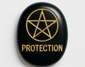 May include: Black, oval-shaped stone with a gold pentagram design and the word "PROTECTION" in gold lettering. The pentagram is enclosed in a circle. The stone has a smooth, polished surface.